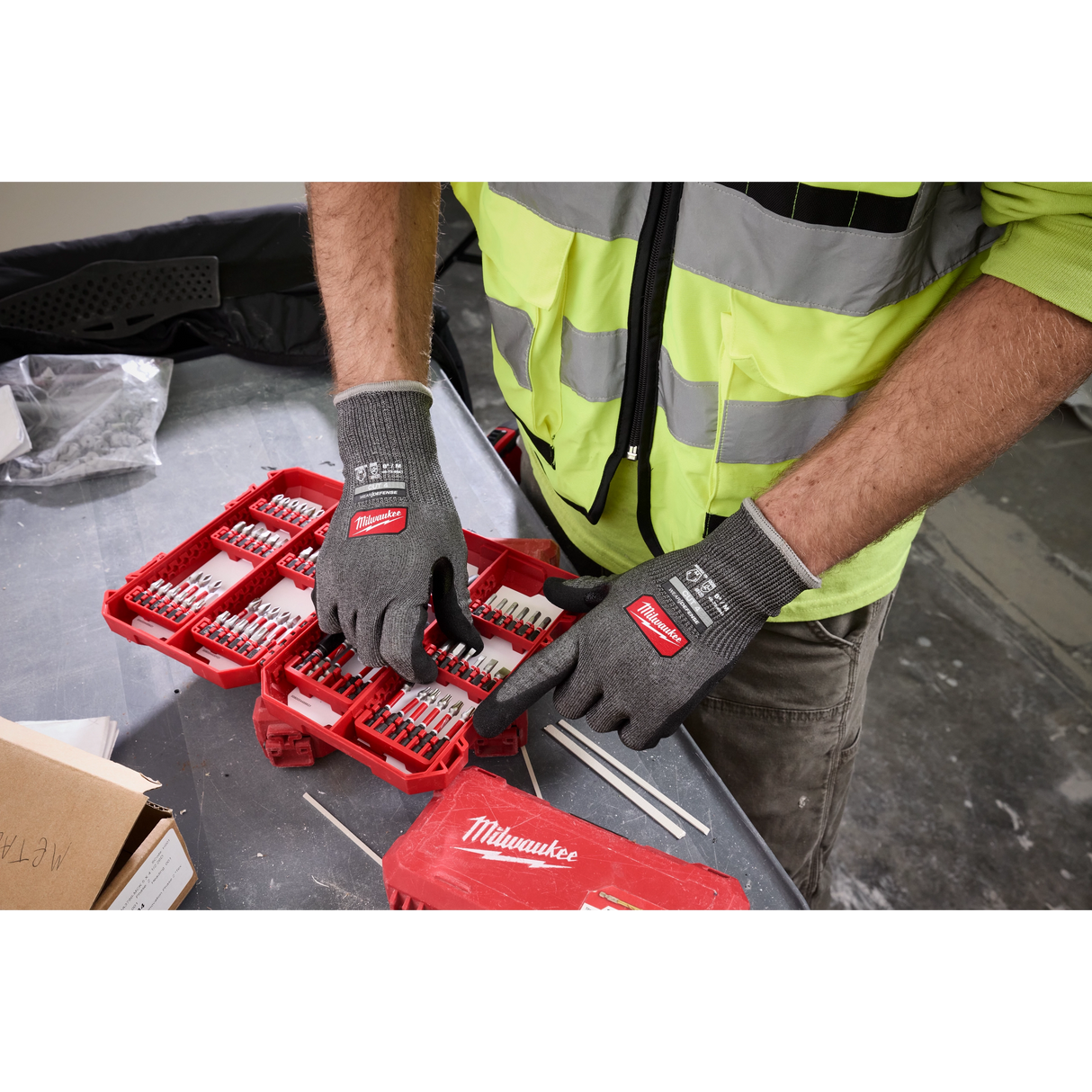 Worker organizing drill bits wearing Milwaukee Cut Level 4 High Dexterity gloves