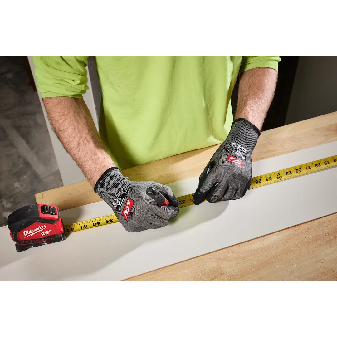 Person measuring wood wearing Milwaukee Cut Level 3 High Dexterity gloves