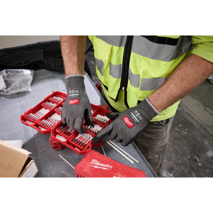 Worker organizing drill bits wearing Milwaukee Cut Level 4 High Dexterity gloves