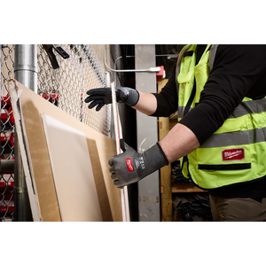 Worker handling boards wearing Milwaukee Cut Level 3 High Dexterity gloves