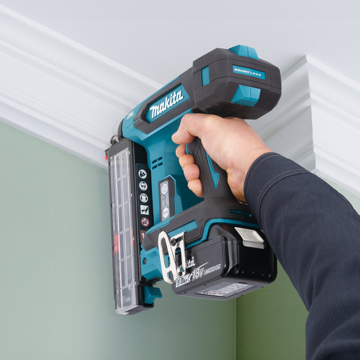 Person using a Makita nail gun on a ceiling