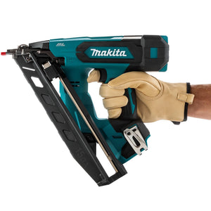 Makita nail gun held by a person wearing a beige glove on a white background