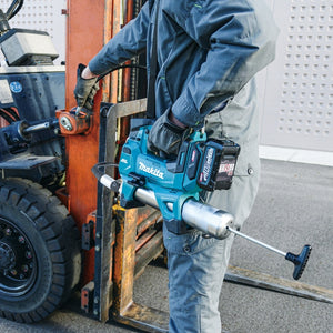 Person using a Makita power tool on a forklift in an industrial setting