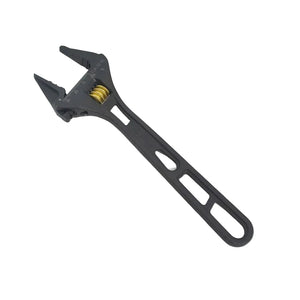 Black adjustable wrench on a light gray background