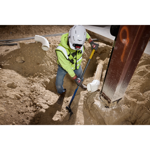 Worker digging while wearing Milwaukee Cut Level 5 High Dexterity gloves