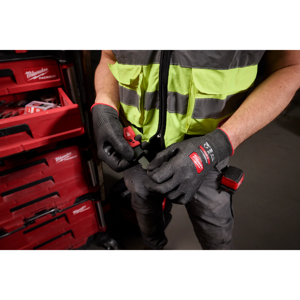 Worker using hand tool while wearing Milwaukee Cut Level 5 High Dexterity gloves
